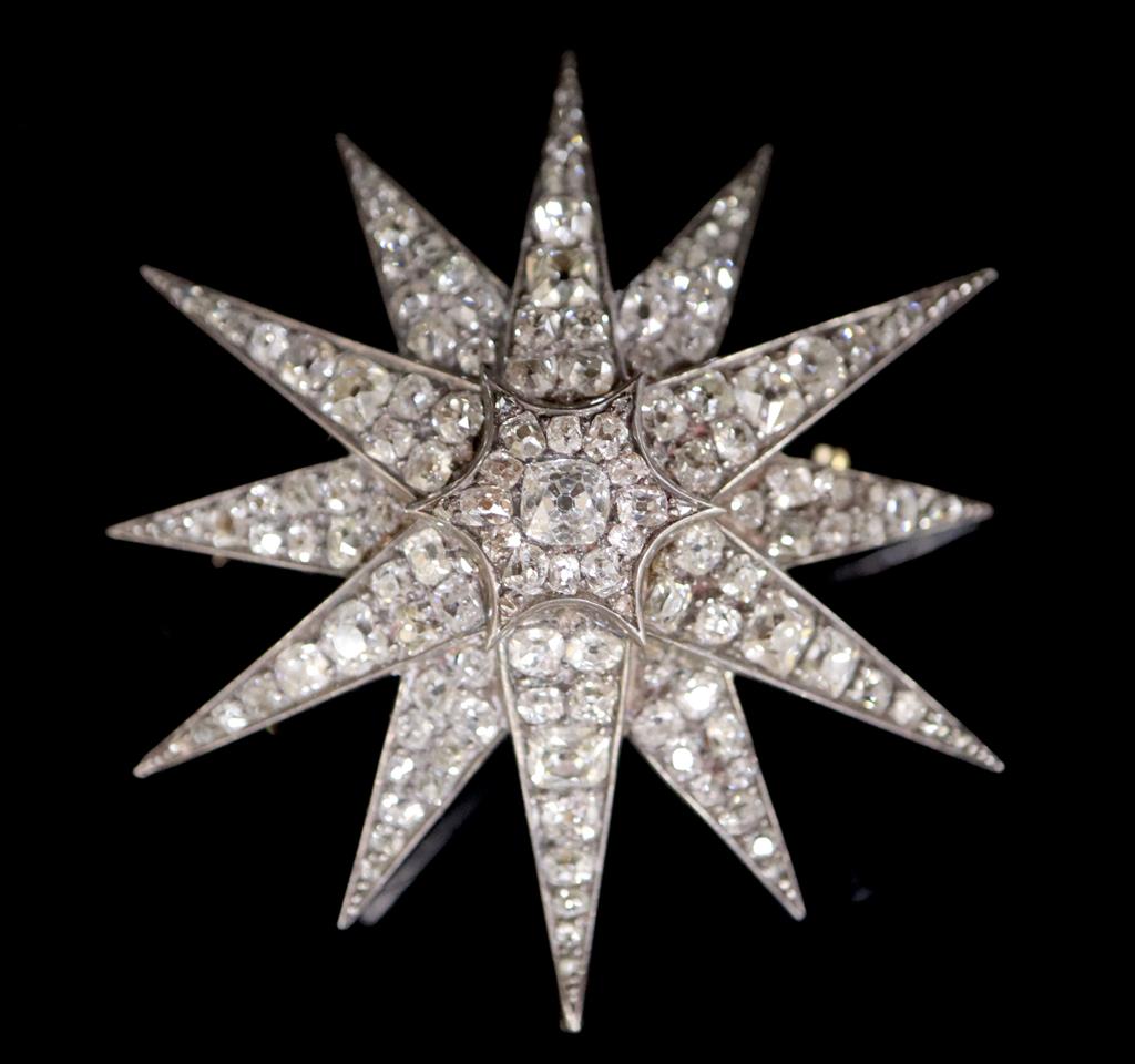 A Victorian gold, silver and graduated old round and cushion cut diamond set starburst pendant brooch,